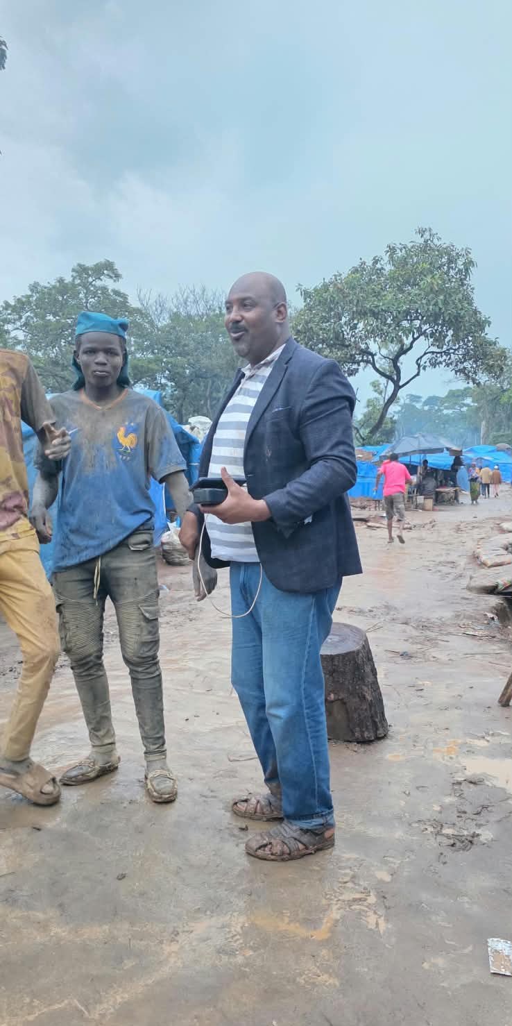 In discussion with a worker on the camp ground.