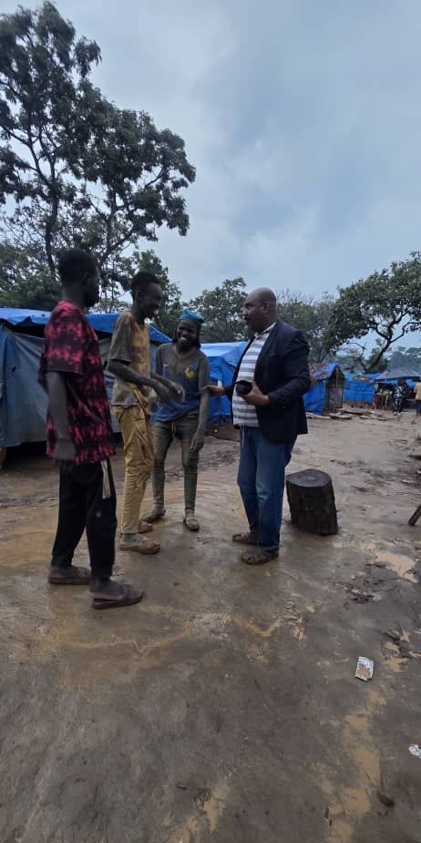 Talking with workers beside the shelters after rain.